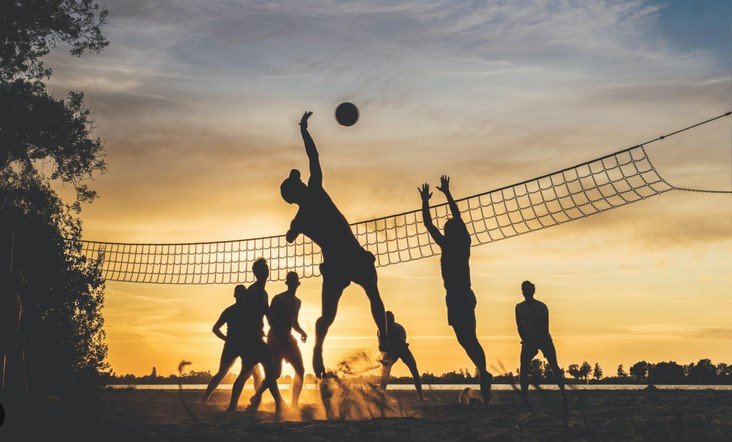 community members playing volleyball 