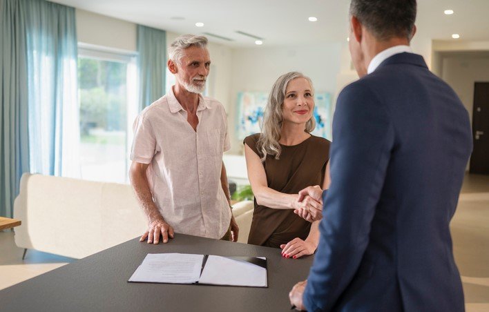 a broker shaking hands with clients